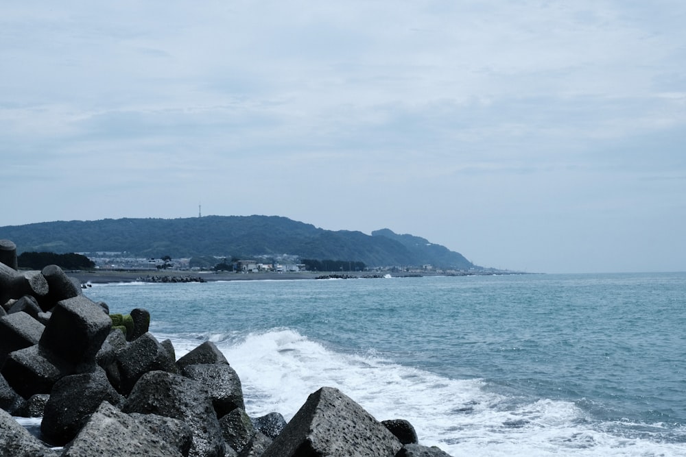 a view of the ocean from a rocky shore