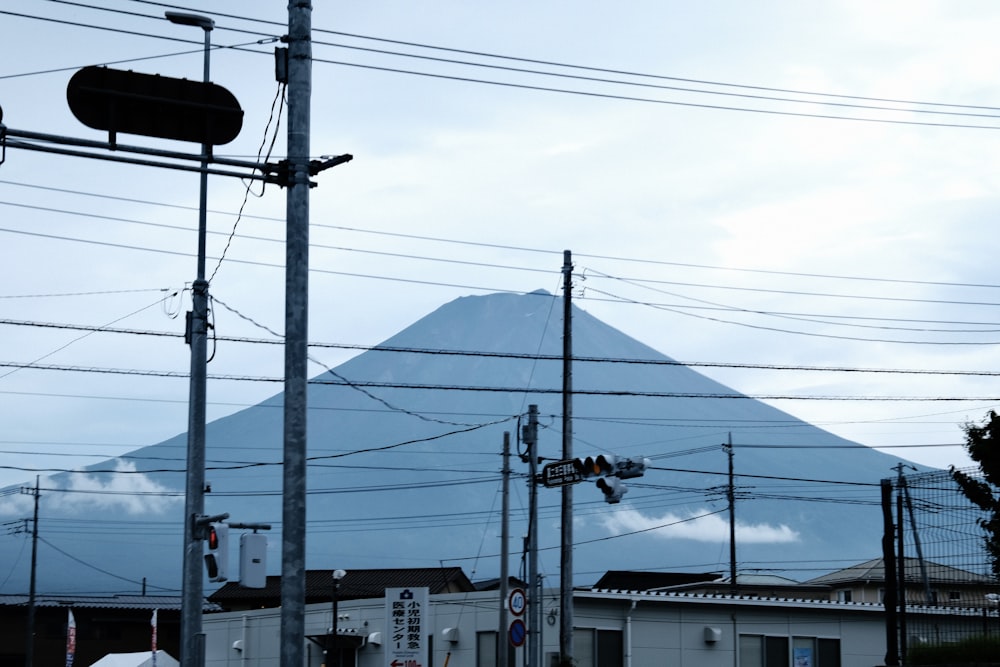 a view of a mountain with power lines in the foreground