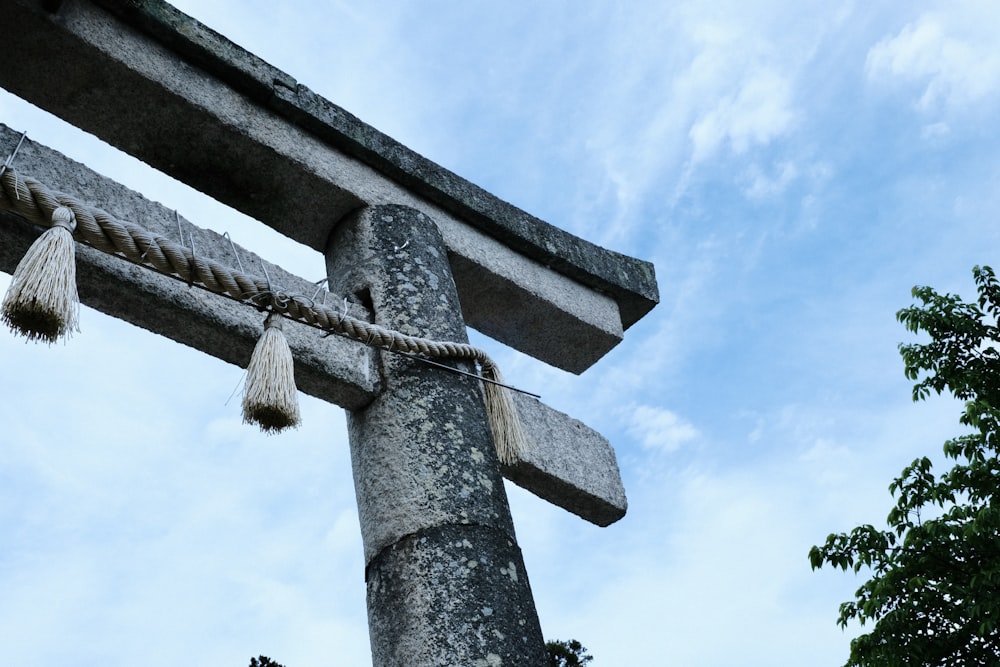 a wooden cross with tassels hanging from it