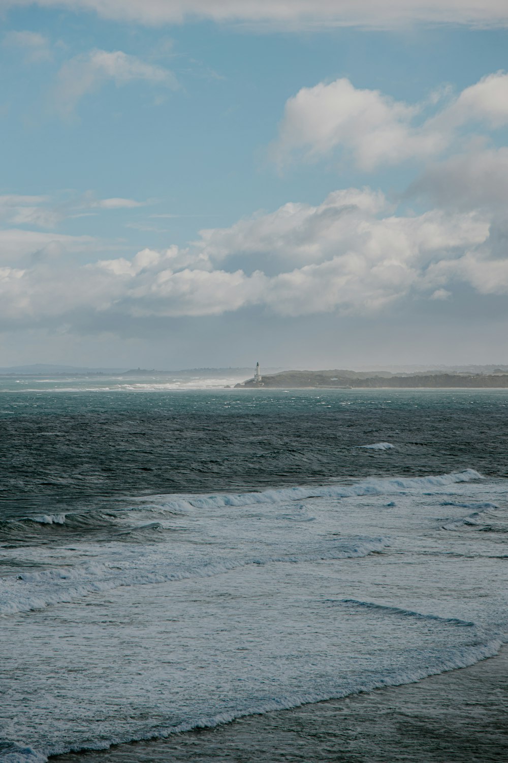 a large body of water sitting under a cloudy sky