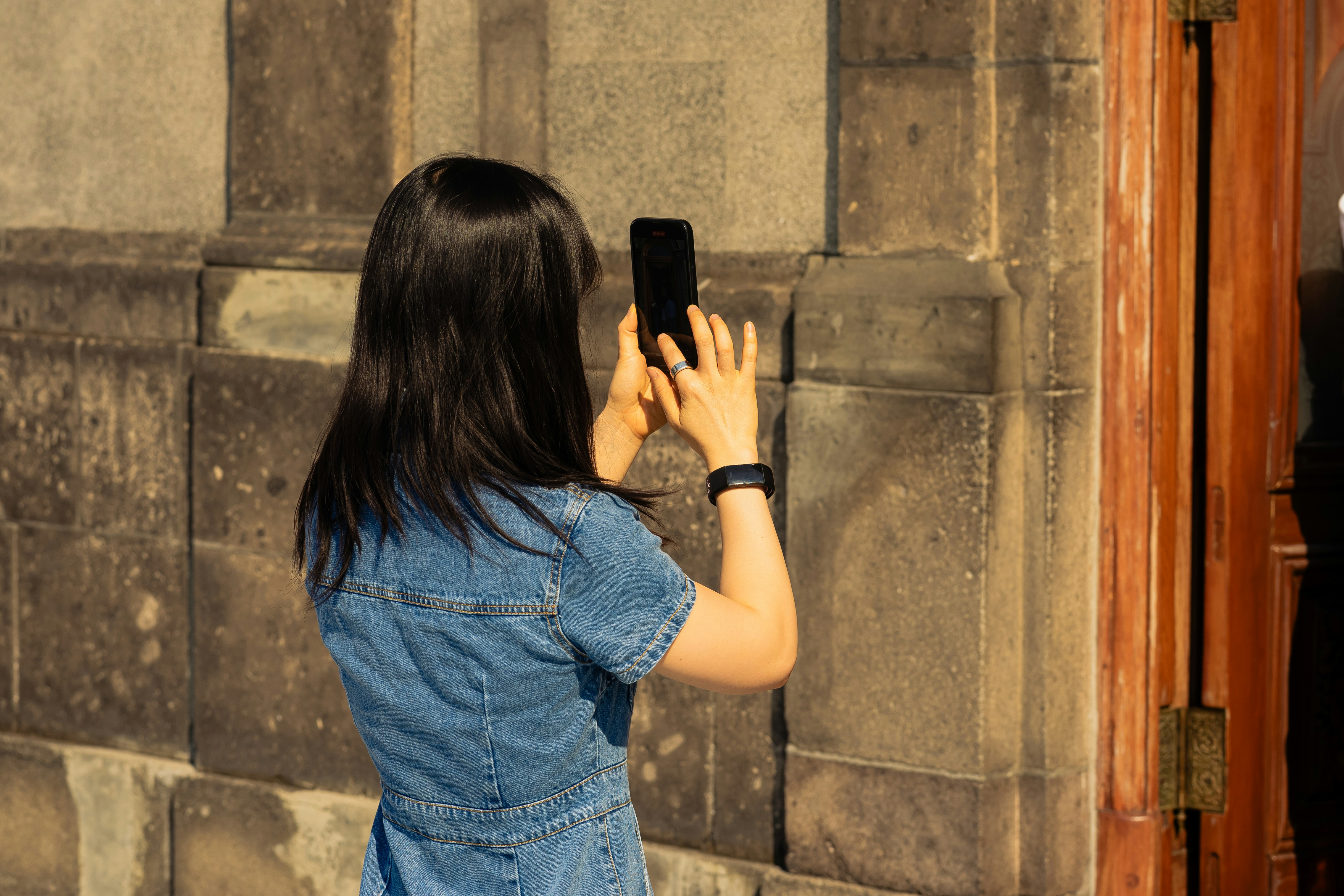 a woman taking a picture of herself with her cell phone