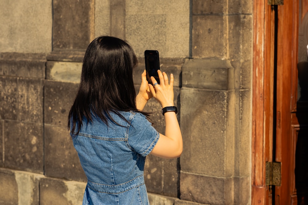 a woman taking a picture of herself with her cell phone
