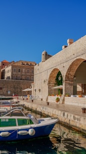 a blue and white boat sitting in the water