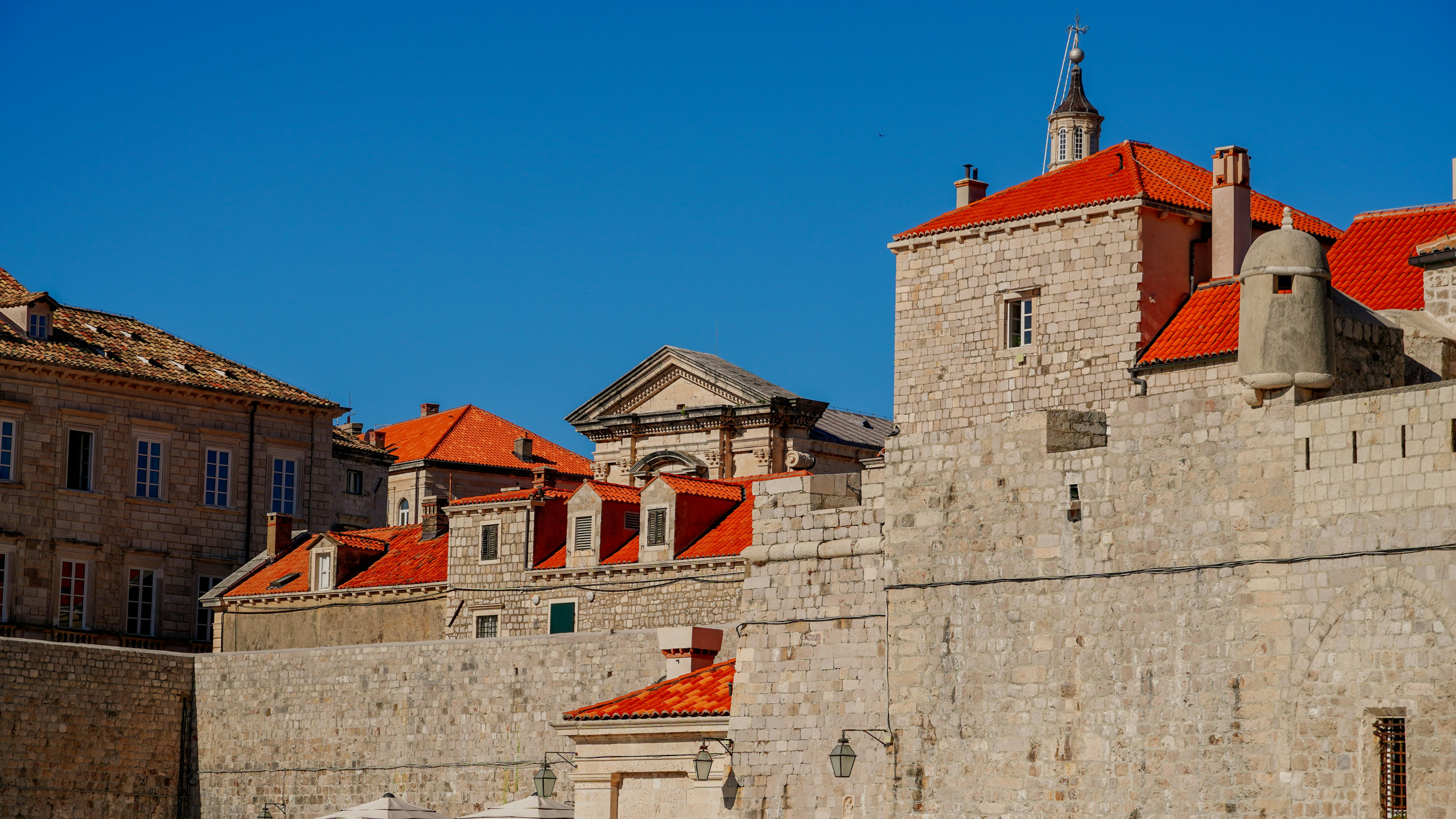 a large stone building with red roof tops