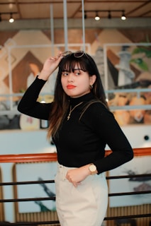 Portrait of a confident woman wearing bold, colorful glasses indoors