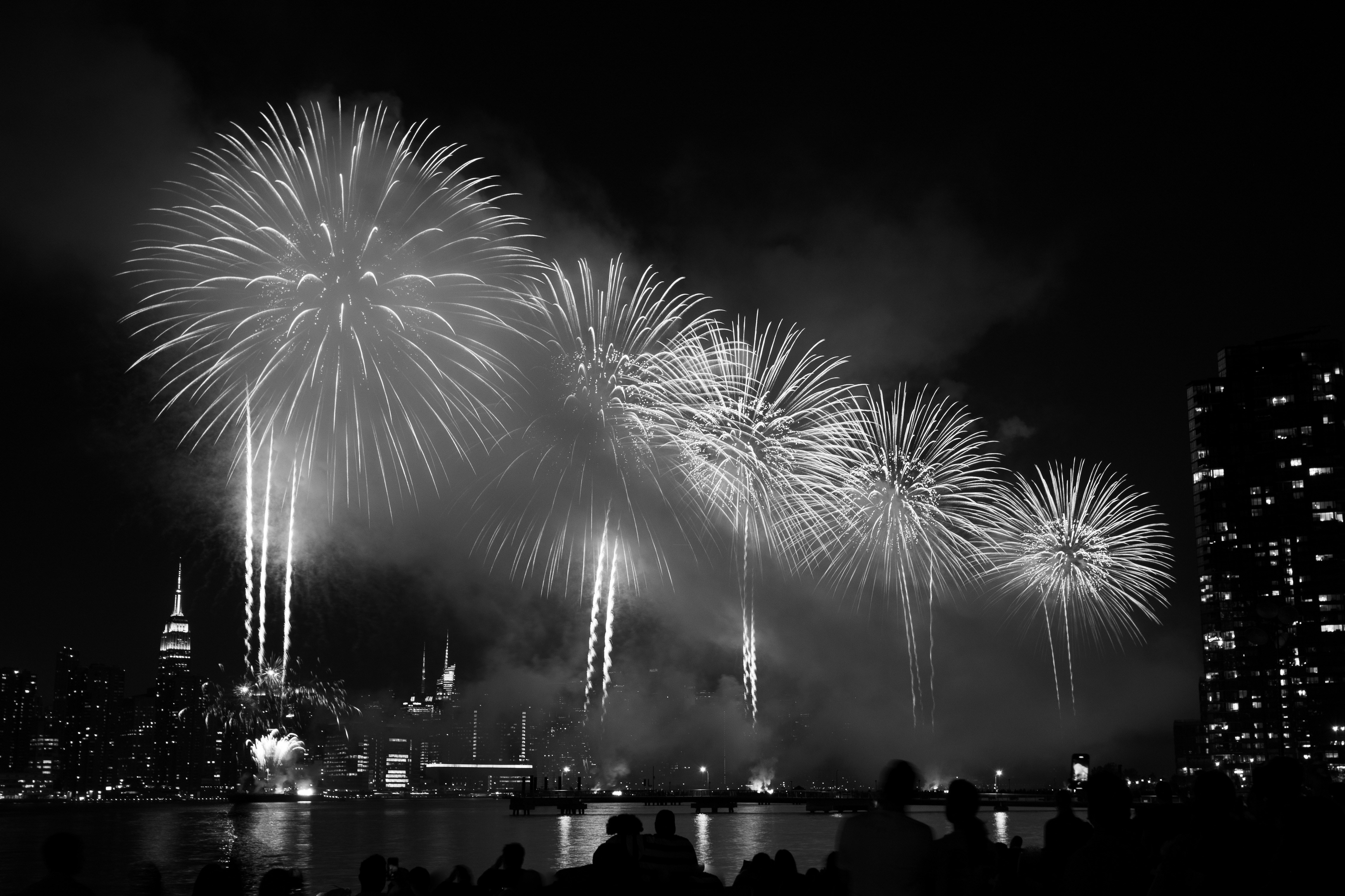 a black and white photo of a fireworks display