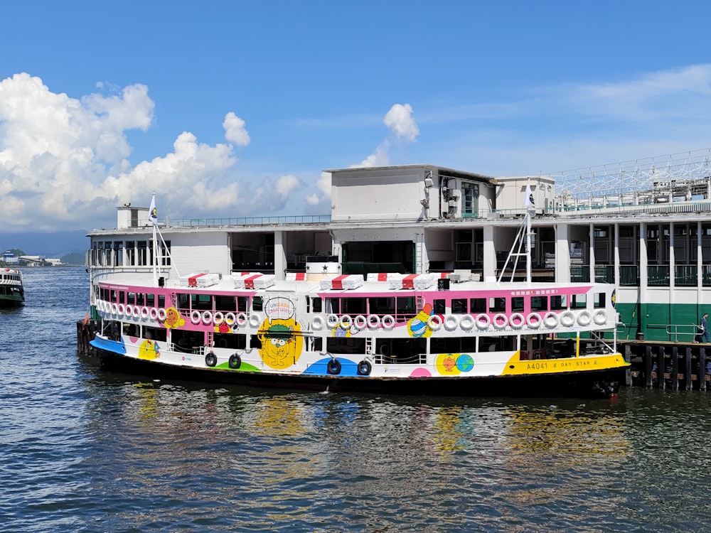 a colorful boat is docked at a pier