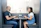 Two business colleagues discussing work with laptops in a modern office