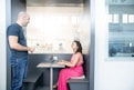 A professional consultant discussing insurance options with a client in a modern office setting.