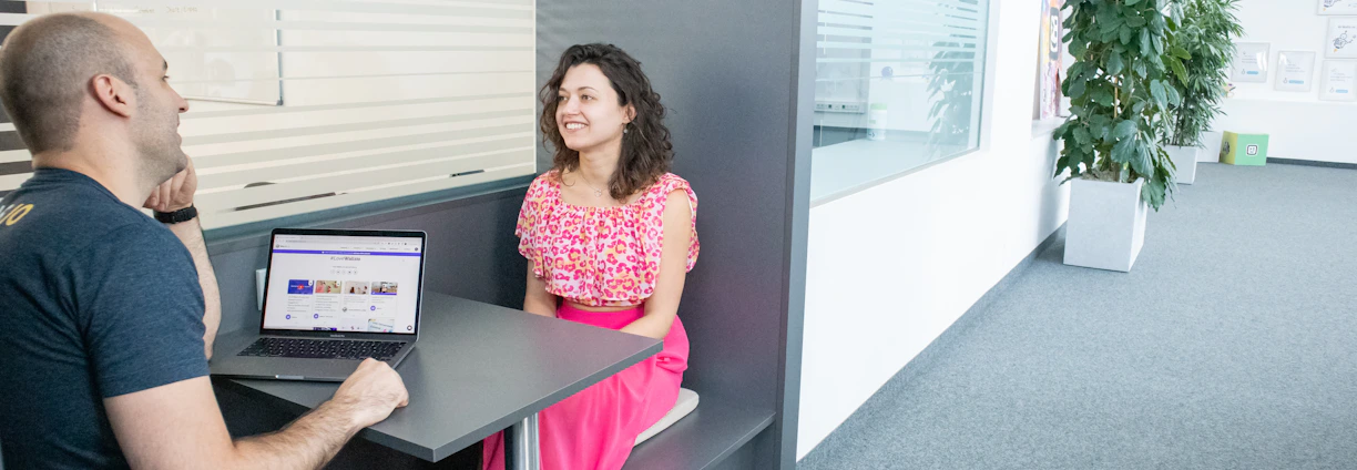 A friendly consultant discussing plans with a small business owner in a cozy office.