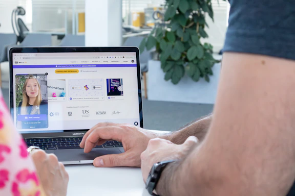 A friendly team member engaging with clients over a video call, surrounded by social media icons.
