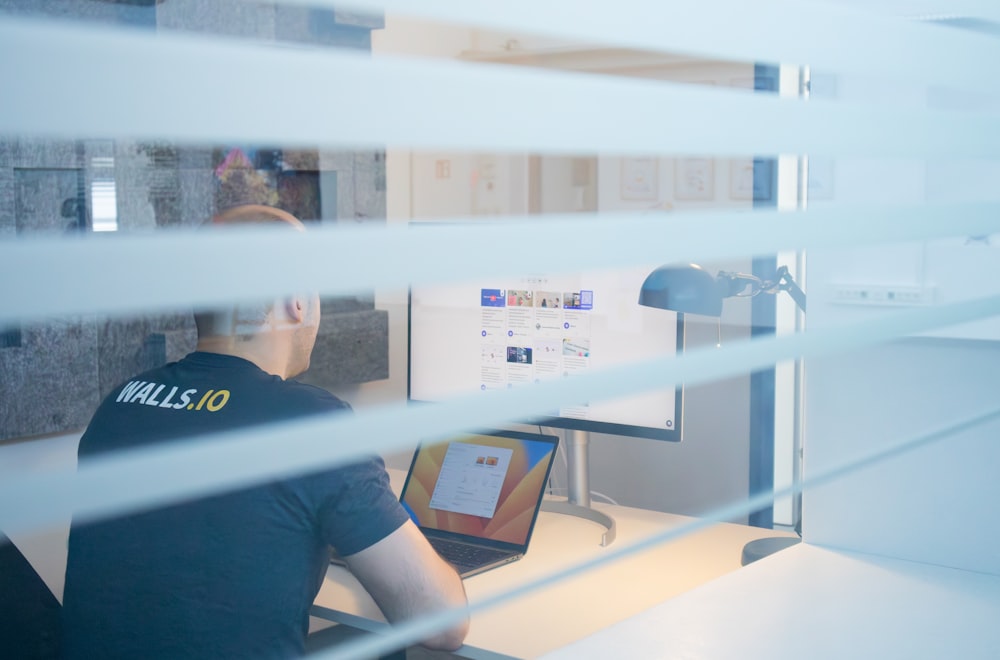 a man sitting at a desk in front of a computer