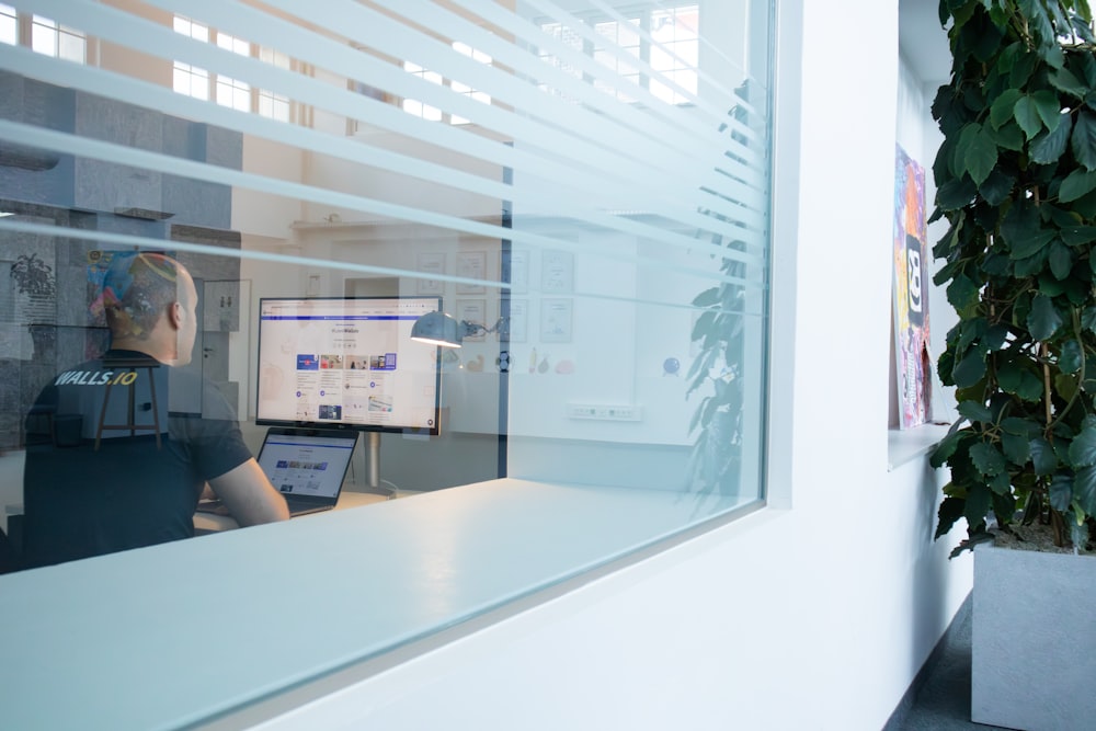 a man sitting at a desk in front of a computer