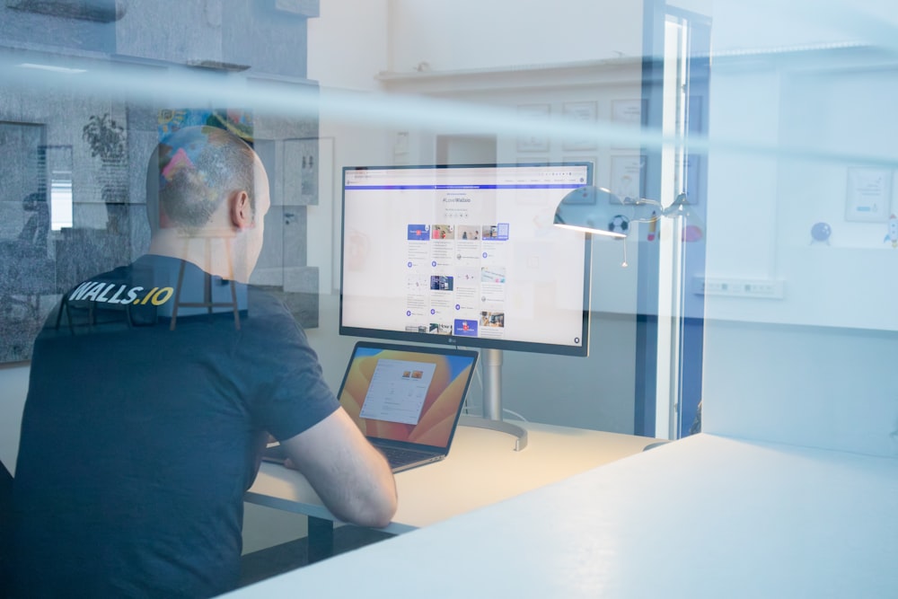 a man sitting at a desk in front of a computer