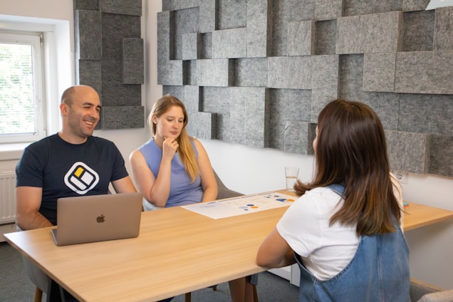Three founders of Ethos Talent standing together in a modern Leicester office, with sage green accents visible in the background.