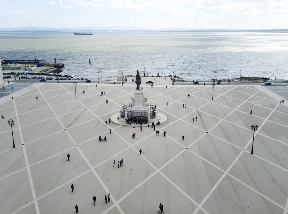 an aerial view of a square with a statue in the middle