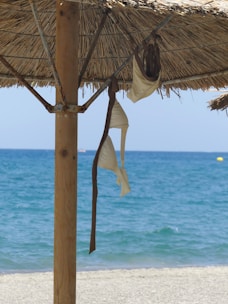 A stylish beach umbrella set up on a sandy beach.