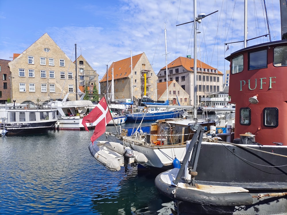 several boats docked in a harbor with buildings in the background