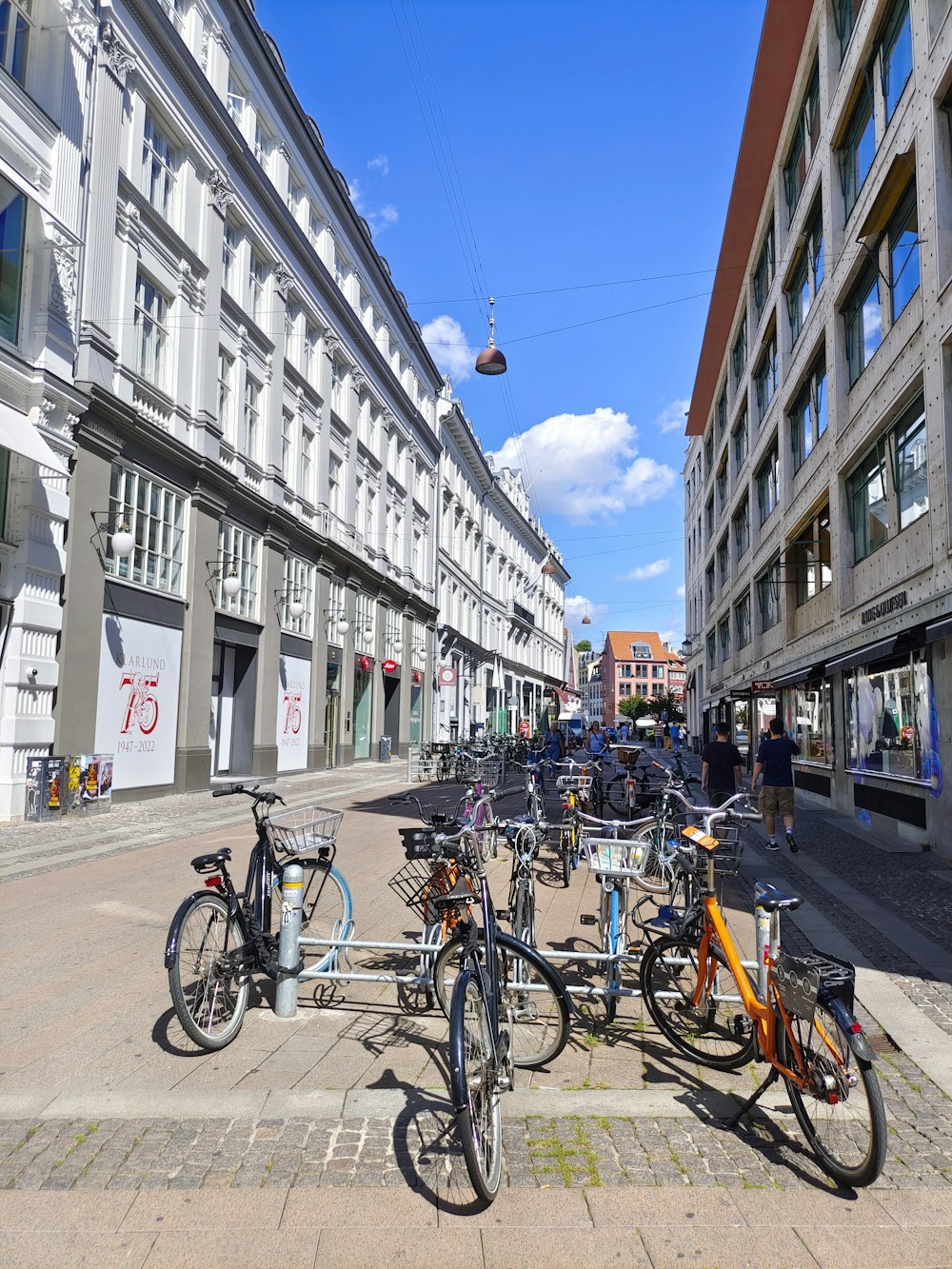 a group of bicycles parked on the side of a street