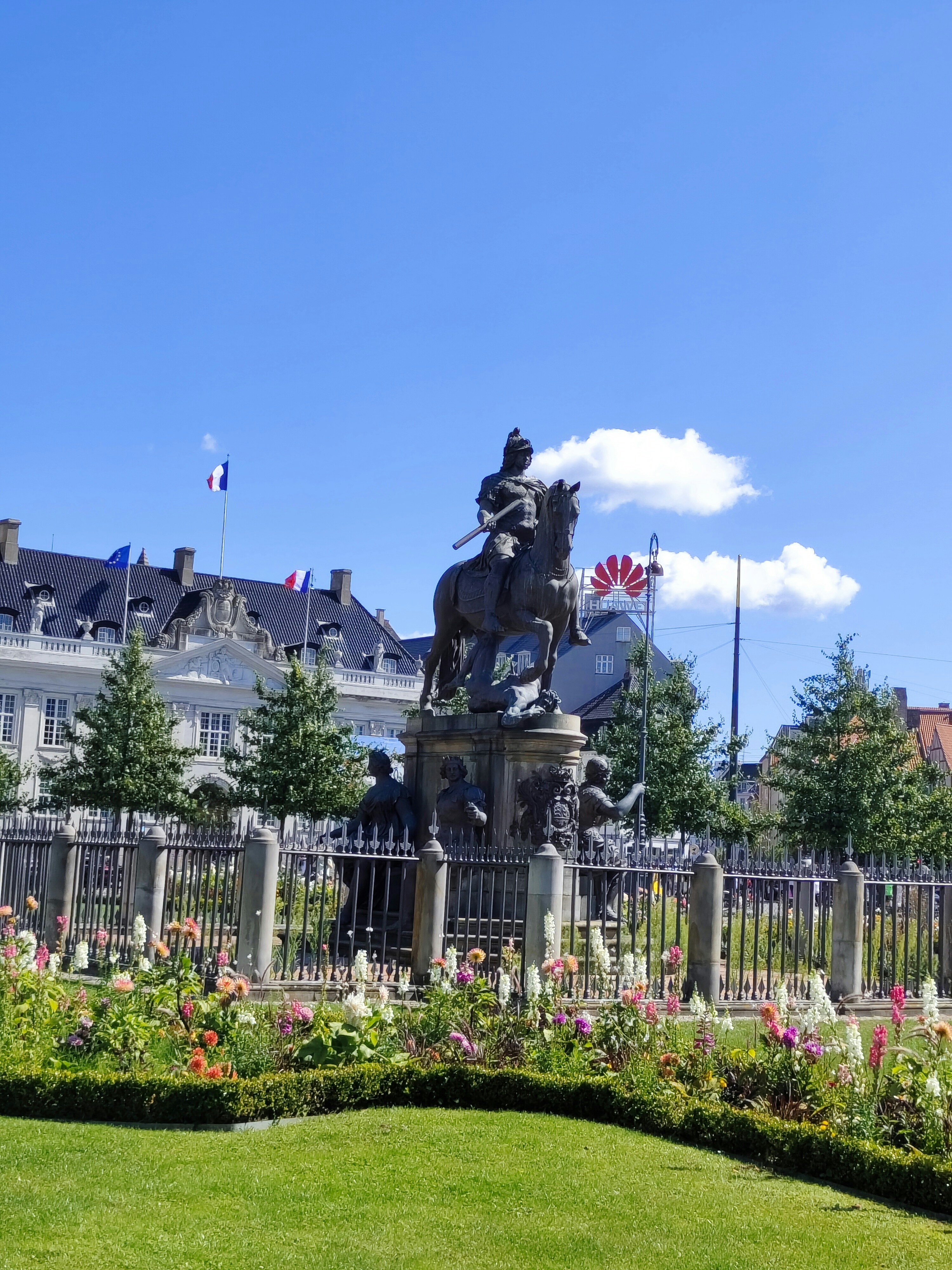 a statue of a man on a horse in front of a building