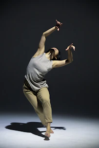 A researcher presenting a dance movement study in a conference hall.