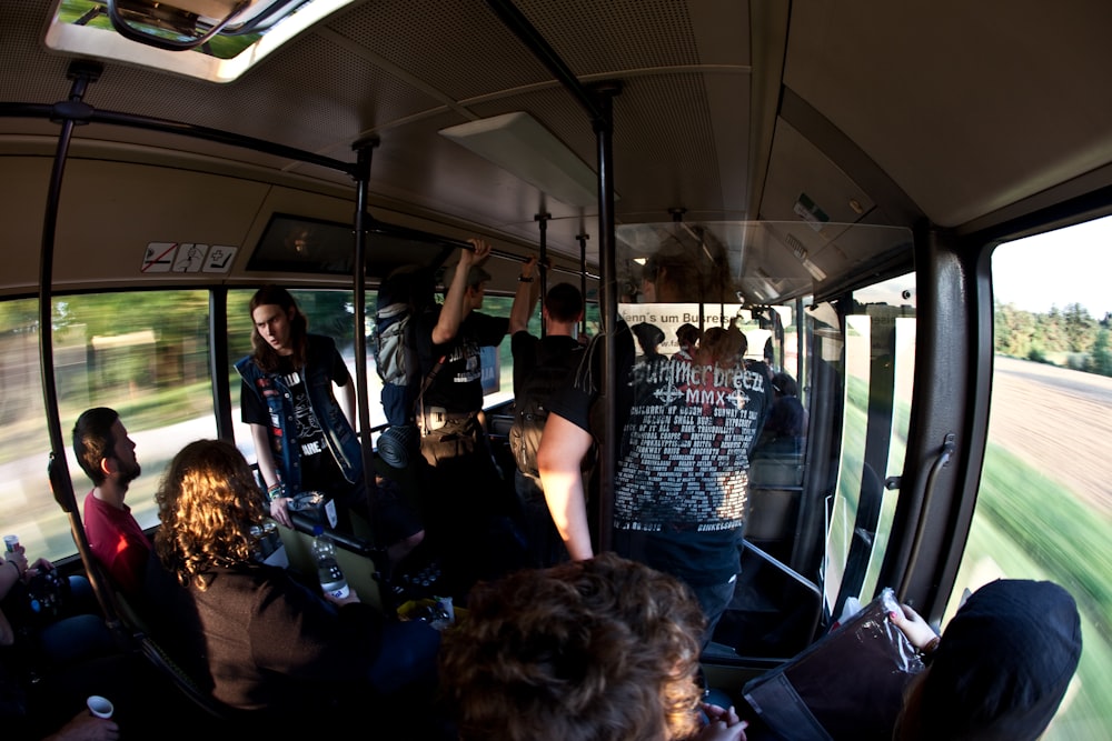a group of people riding on the back of a bus