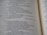 A close-up view of an open book showcasing text in neat, uniform columns. The text is dark against a light-colored page, organized in a structured and easy-to-read manner.