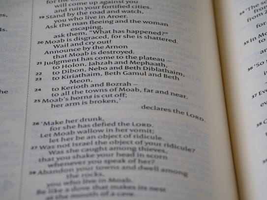A close-up view of an open book showcasing text in neat, uniform columns. The text is dark against a light-colored page, organized in a structured and easy-to-read manner.