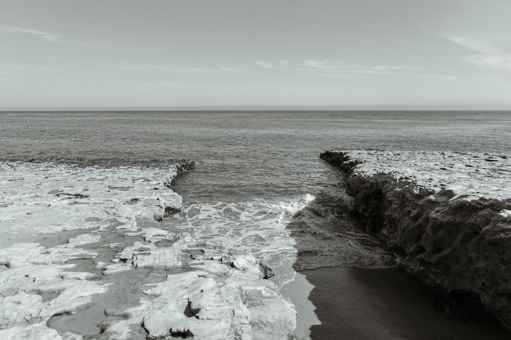 a black and white photo of a rocky beach