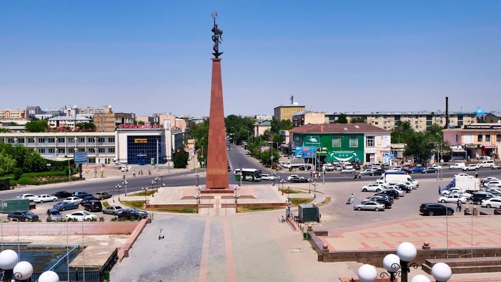 a city square with a tall obelisk in the middle