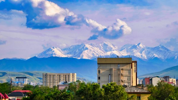 A view of a city with mountains in the background — Bishkek, Kyrgyzstan
