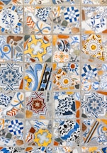 a close up of a tiled wall with many different designs