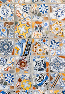 Close-up of colorful, patterned floor tiles arranged in a vibrant mosaic.