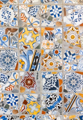 Mosaic tile detail featuring colorful geometric shapes in a vibrant entryway.