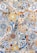 A colorful mosaic pattern composed of various geometric and floral designs. The intricate tiles feature vibrant colors such as blue, yellow, orange, and white, arranged in a patchwork style.