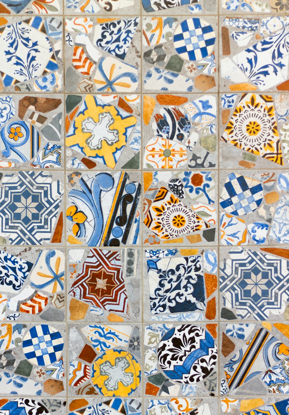 a close up of a tiled wall with many different designs