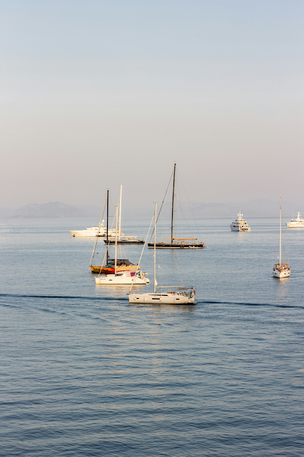 a group of boats floating on top of a large body of water