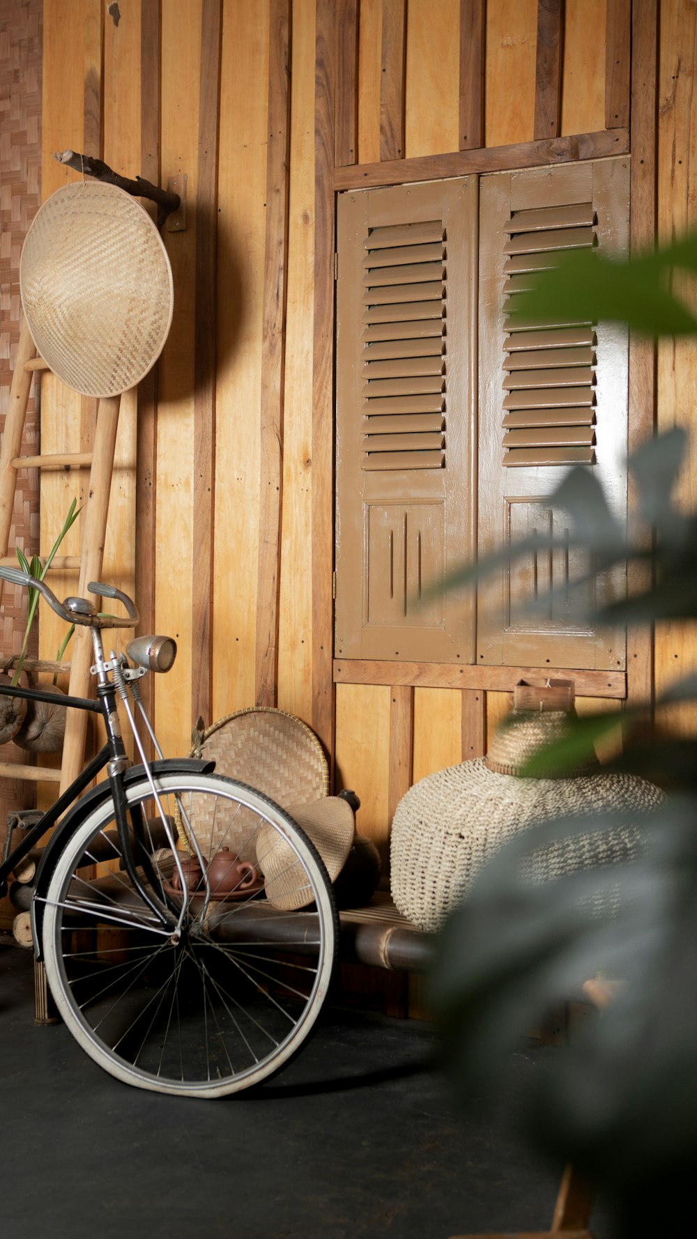 a bicycle parked in a room with wooden walls