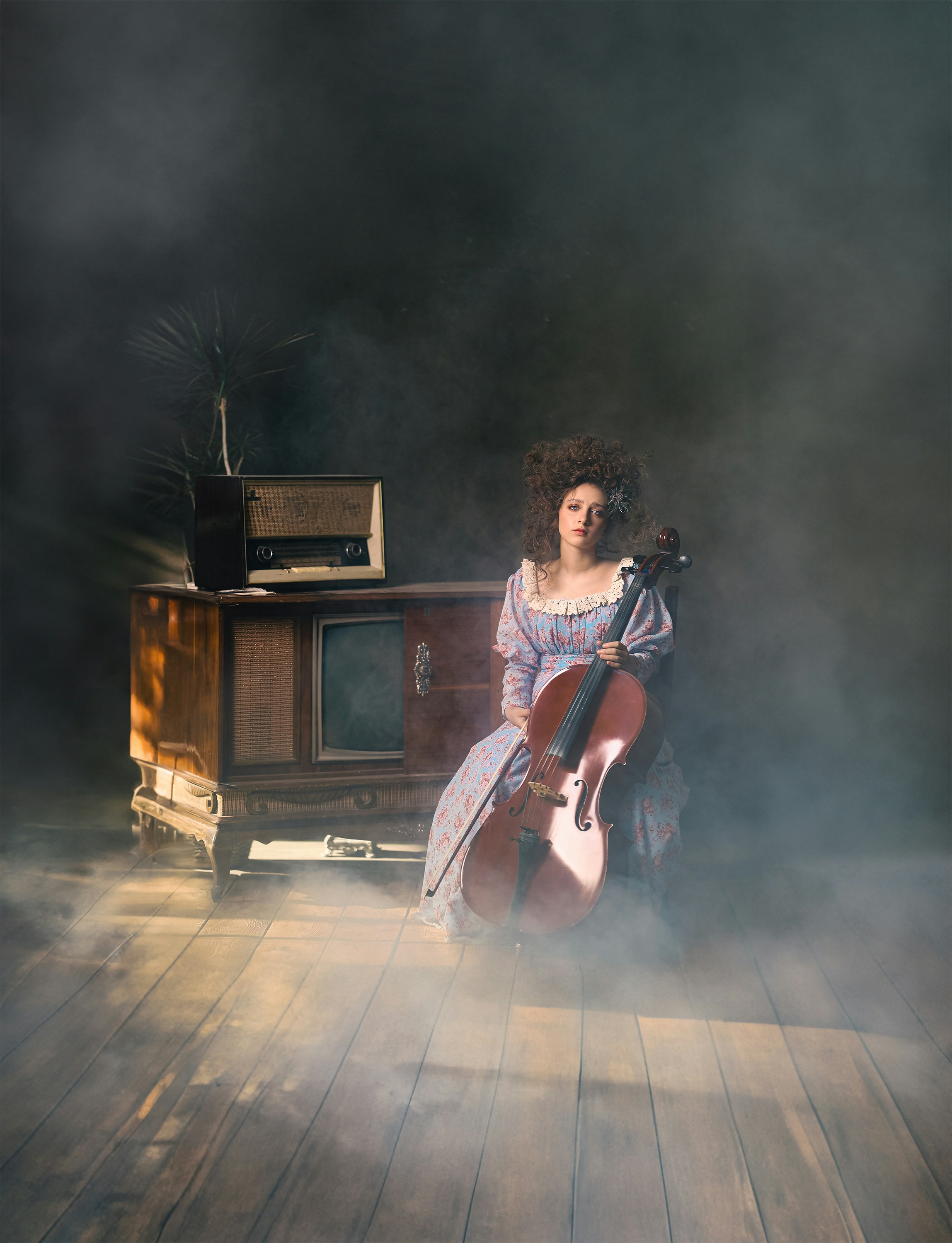 a woman sitting in a chair with a violin