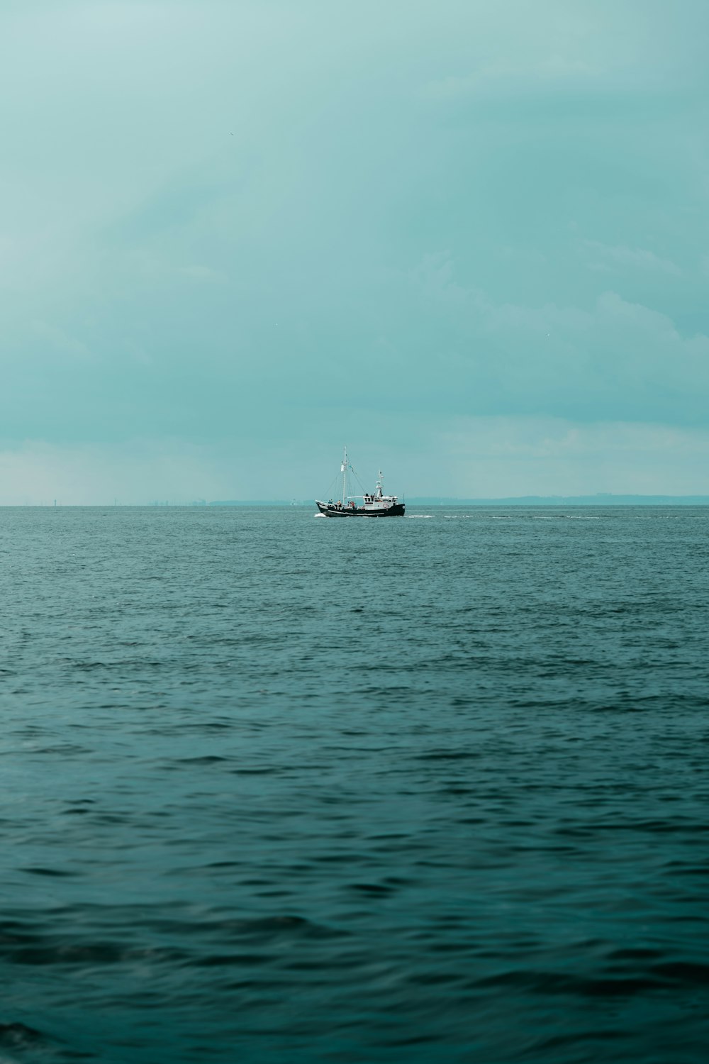 a boat in the middle of a large body of water