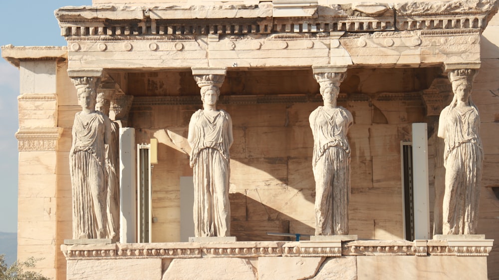 a group of statues on the side of a building