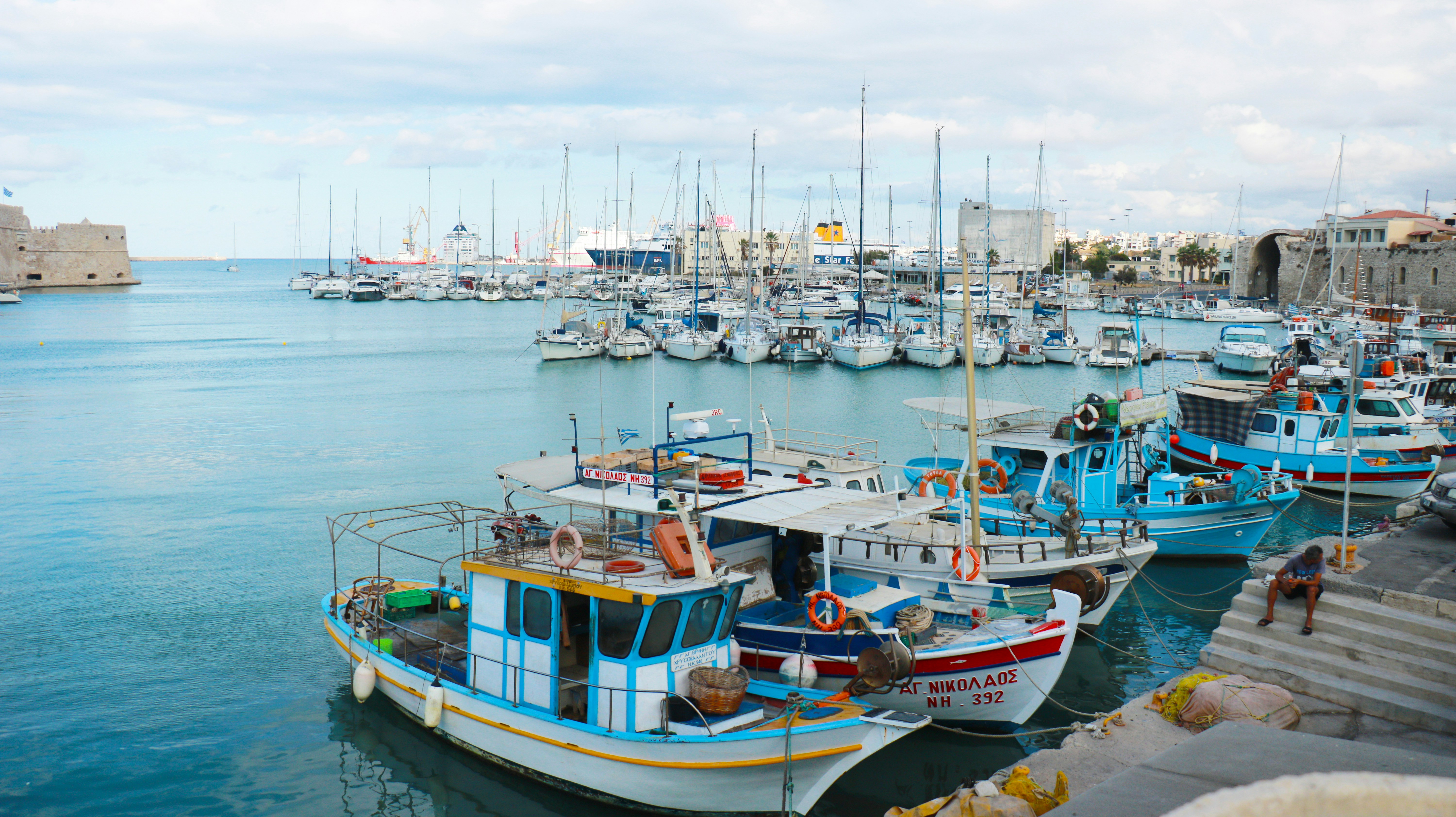 a harbor filled with lots of boats on top of water