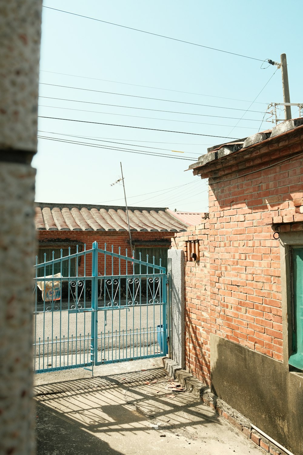 a red brick building with a blue gate