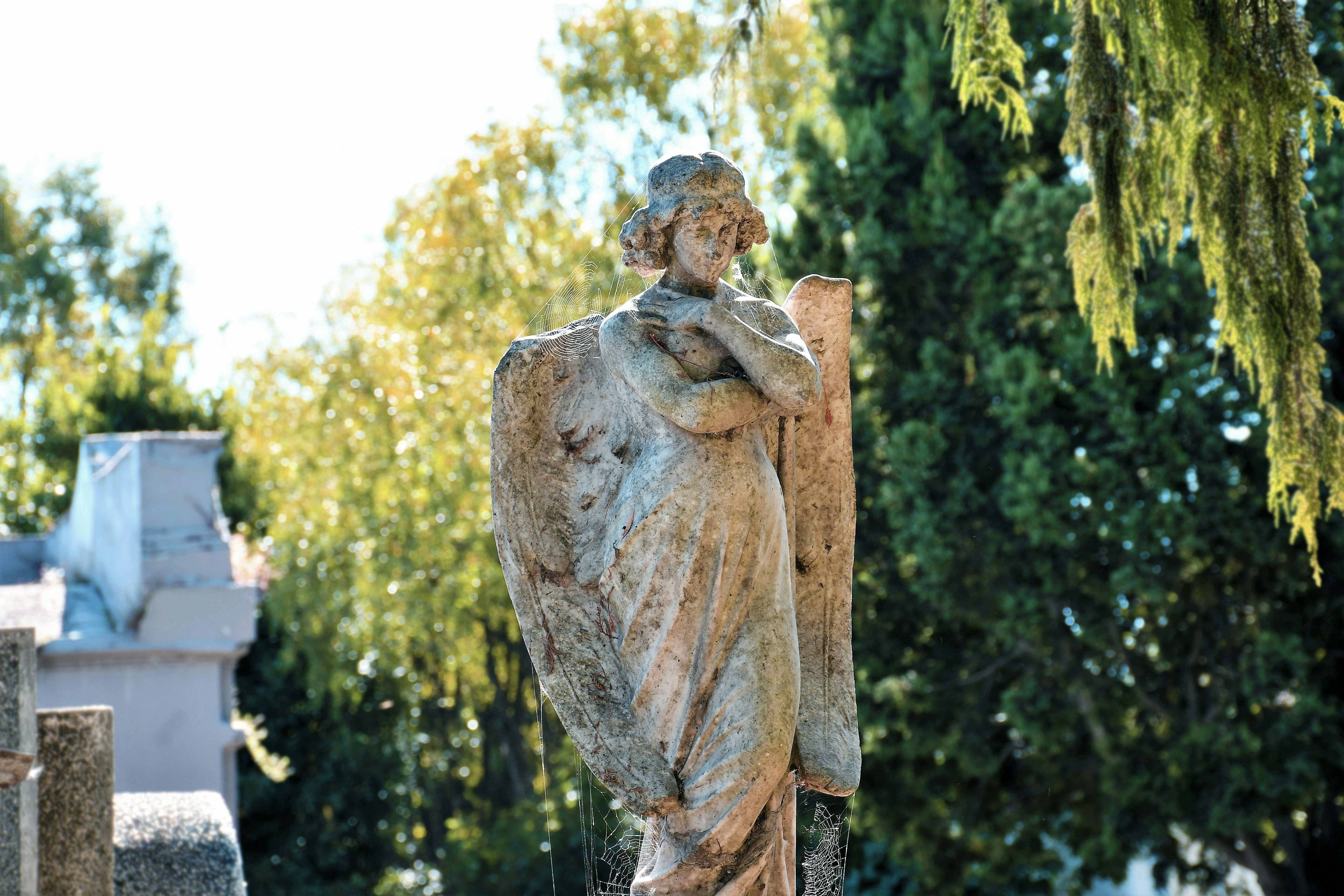 a statue of a woman holding a book