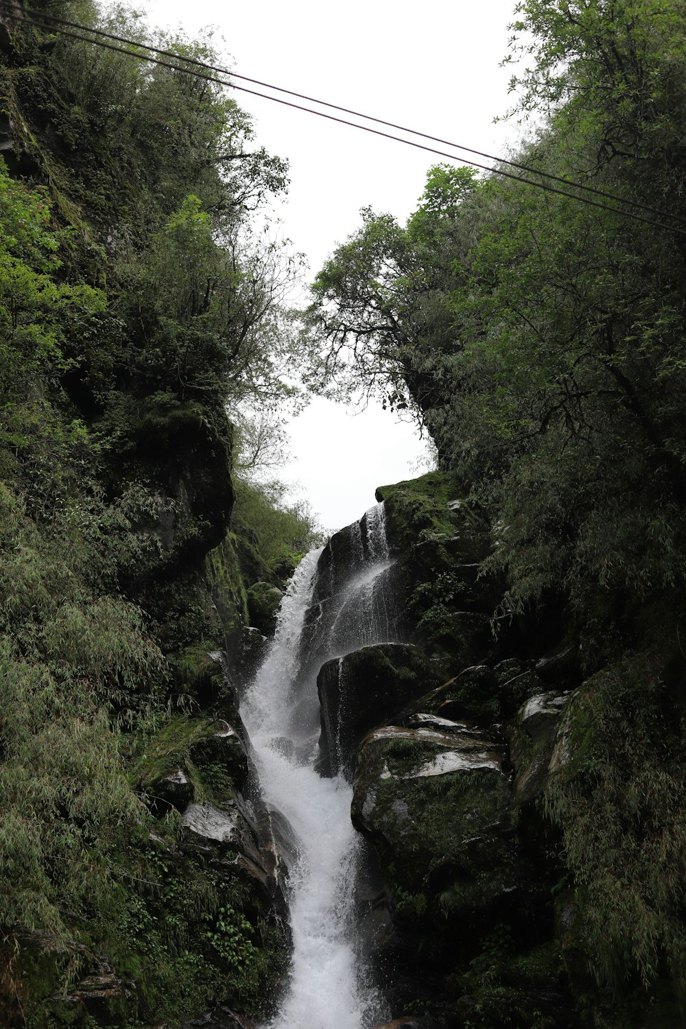 a small waterfall in the middle of a forest