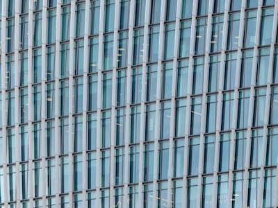 Close-up of a modern office building facade with glass windows.