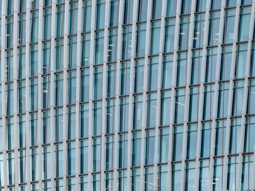 Wide shot of a commercial building featuring large glass windows framed by aluminum composite panels.