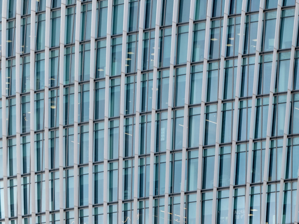 a plane flying in front of a very tall building