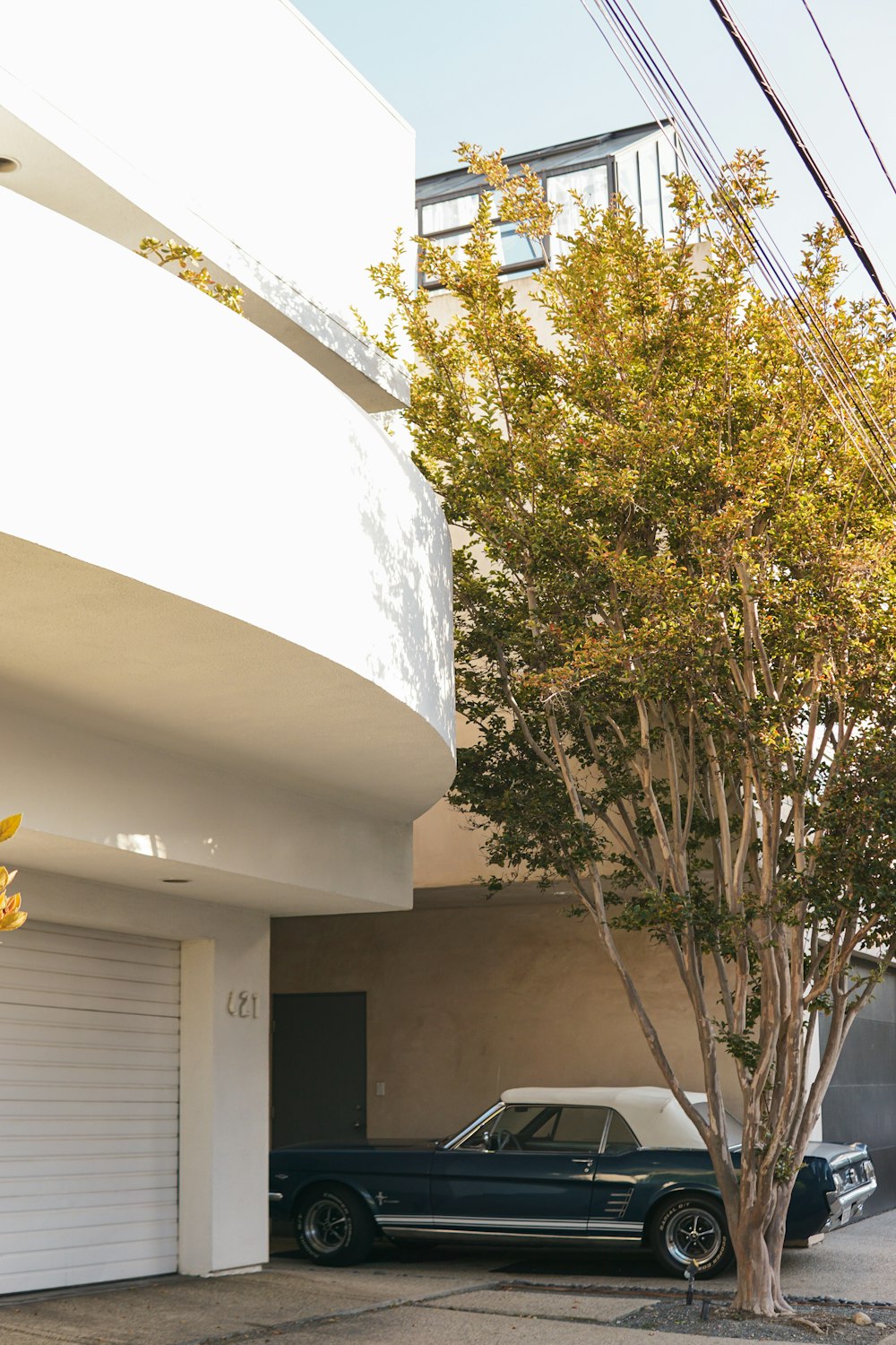 a black car parked in front of a white building