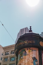 A clean portable toilet set up outdoors with a San Francisco cityscape in the background